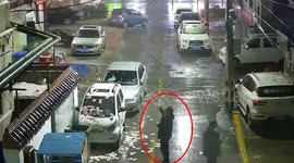 Man on IV drip guards pile of cash after £8,000 falls from residential building in China