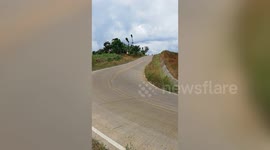 Motorcycle rider takes sharp corner while sidecar lifts dangerously in the air