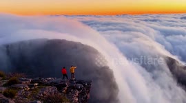 Ethereal waterfall of clouds flows down mountainside in southern China