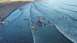 Fifty Santas take to the sea on paddleboards and kayaks for charity