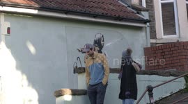 Locals gather to view Banksy's latest artwork in Bristol suburb