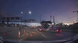 Out-of-control car hits traffic cones and drifts backwards to another lane in the Philippines