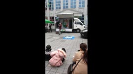 Korean man creating giant soap bubbles on the street