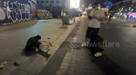 Pitiful moment when Dog and homeless child beg for food at the pedestrian street in Vietnam