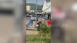 Crazed wife clings to husband's car windscreen after 'lover's spat'