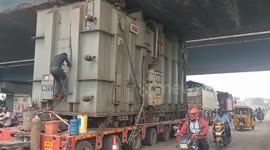 Stuck between a bridge and a hot place! Truck catches fire after getting lodged underneath flyover in India