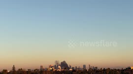 DTLA Structure fire at sunset with big plume of black smoke 4k