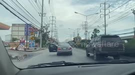 Dangerous driver reaches over passenger seat to close car door with his foot