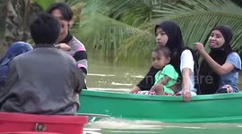 Thai pupils ride boats to school due to flash floods