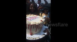 Anti-SARS protesters sing after receiving a cake in Abuja, Nigeria