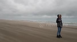 High winds from Storm Bella sweep across beach in Netherlands