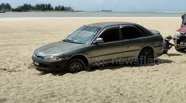 Car stuck in sand at beach
