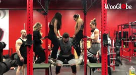 US gymgoer manages to lift and squat whilst holding bar with FOUR women sitting on top