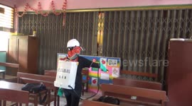 a group of mothers in the field spraying disinfectant at school ahead of face-to-face study at the degree