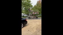 People Riding Huge Sized Shopping Trolly