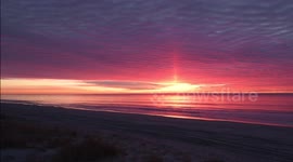 Incredible time-lapse footage of a rare sun pillar and close up of the sun during fiery sunrise off the New York coast