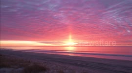 Incredible footage of a rare sun pillar and sun close-up during fiery sunrise off the New York coast