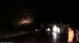 Car hit a cow crossing a road in Indonesia