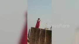 Police officials along with fire brigade team rescue woman from committing suicide in western India