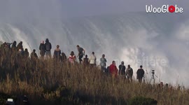 Tourists watch huge waves in Nazare, Portugal