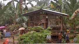 Neighbours carry man’s house to a better position as rain batters Philippines