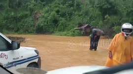 Residents wade through knee-deep floodwater in Philippines