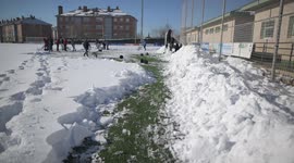 Rayo Majadahonda asks his supporter for help, hands and shovels to remove the snow from the football field in Madrid 13rd January, 2021.