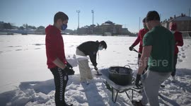 Rayo Majadahonda asks his supporter for help, hands and shovels to remove the snow from the football field in Madrid 13rd January, 2021.