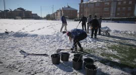 Rayo Majadahonda asks his supporter for help, hands and shovels to remove the snow from the football field in Madrid 13rd January, 2021.