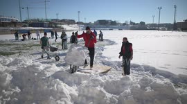 Rayo Majadahonda asks his supporter for help, hands and shovels to remove the snow from the football field in Madrid 13rd January, 2021.