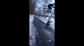German cyclist almost crashes into passerby during stunt
