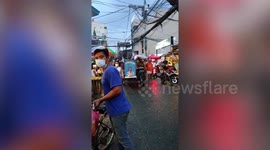 Pet Dog Rides Cart While Wearing Rain Coat