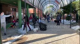 Families clean the snow from access to schools in Madrid 17th January, 2021.