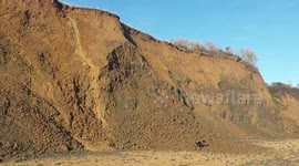 Dog-walker captures shocking moment huge chunk of cliff face crumbles