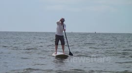 May Sunshine swimming and paddle boarding fun on the beach.