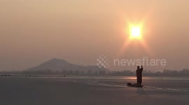 Frozen lake in Kashmir has perfect sunset backdrop