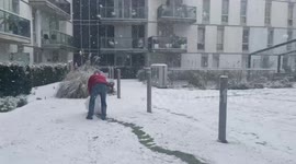 People making huge snow balls in London snow