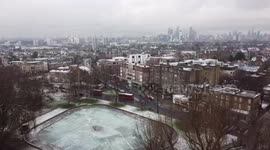 Drone view of snowy London rooftops filmed from Clapham Common