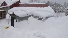 Watch moment snow plunges from garage roof as man clears driveway in Hokkaido, Japan