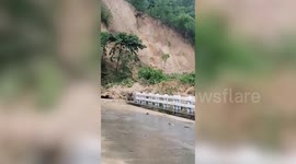 Landslide crashes down hillside blocking road after heavy rain in the Philippines