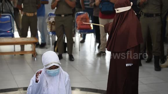 Gay and unmarried couples caned for violating Islamic law in Indonesia