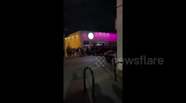 Crowd of people without masks line up outside bar in Oklahoma