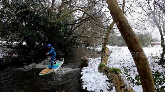 Board-om! UK man paddleboards through snowy countryside to cure 'cabin fever'