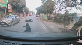 Scooter rider crashes onto ground and rolls like stunt man