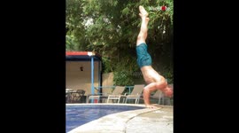 Guy fails to perform handstand at the edge of the pool