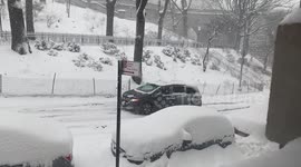 Minivan struggles up a slippery New York hill during the first 2021 snowstorm