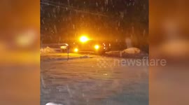 Snow plough clears powder from roads in New York
