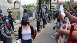 Myanmar protesters hand red roses to police at rally against military coup