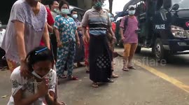 Myanmar woman collapses in tears while pleading with police not to harm protesters