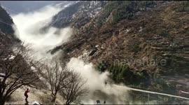 Indian brothers take refuge on roof as devastating torrent of water swamps area